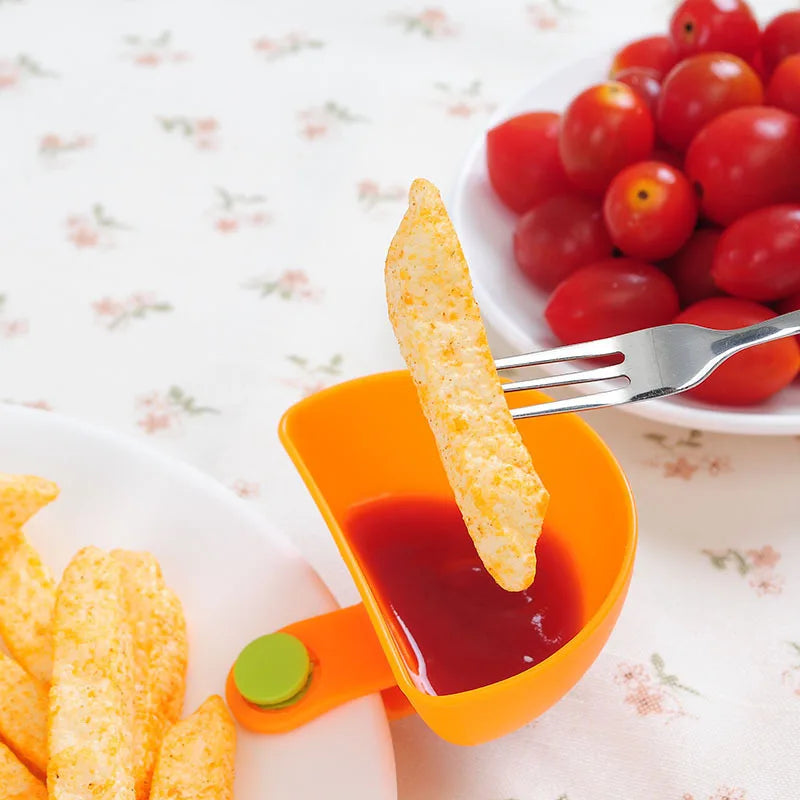 Close-up of clip-on dip bowl attached to plate rim