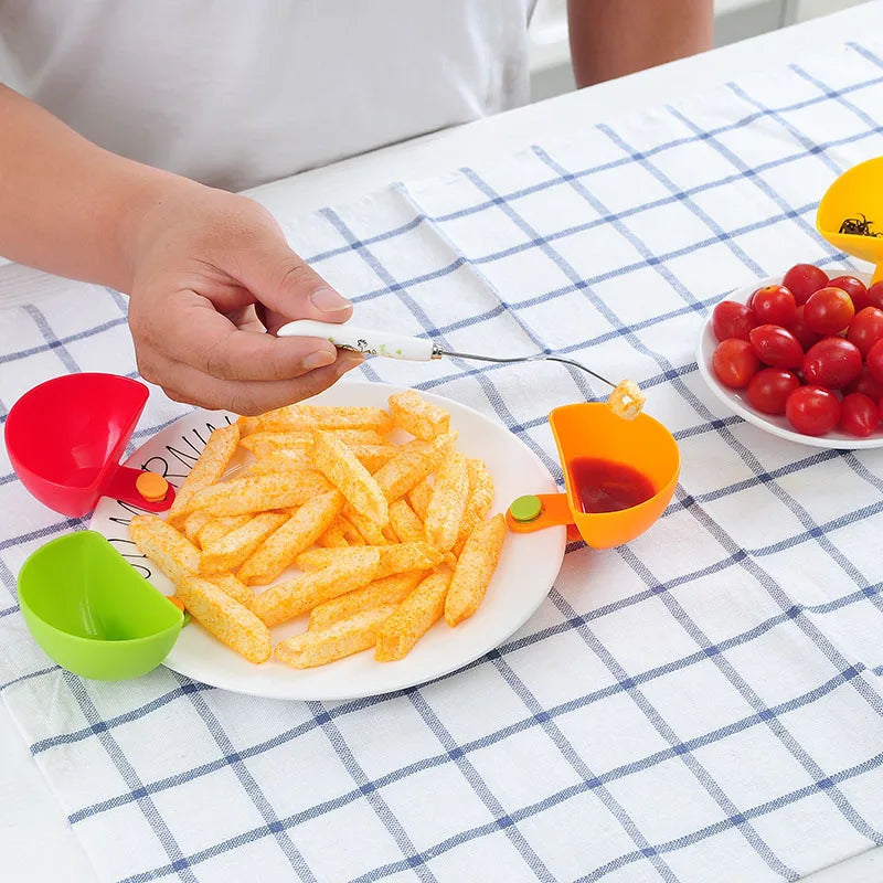 Dip clip bowls holding various sauces on dinner plates