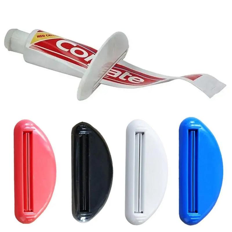 Manual tube squeezer in use on toothpaste tube