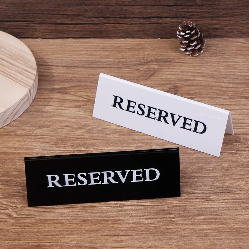 Black acrylic reserved table sign 15x4cm on restaurant table