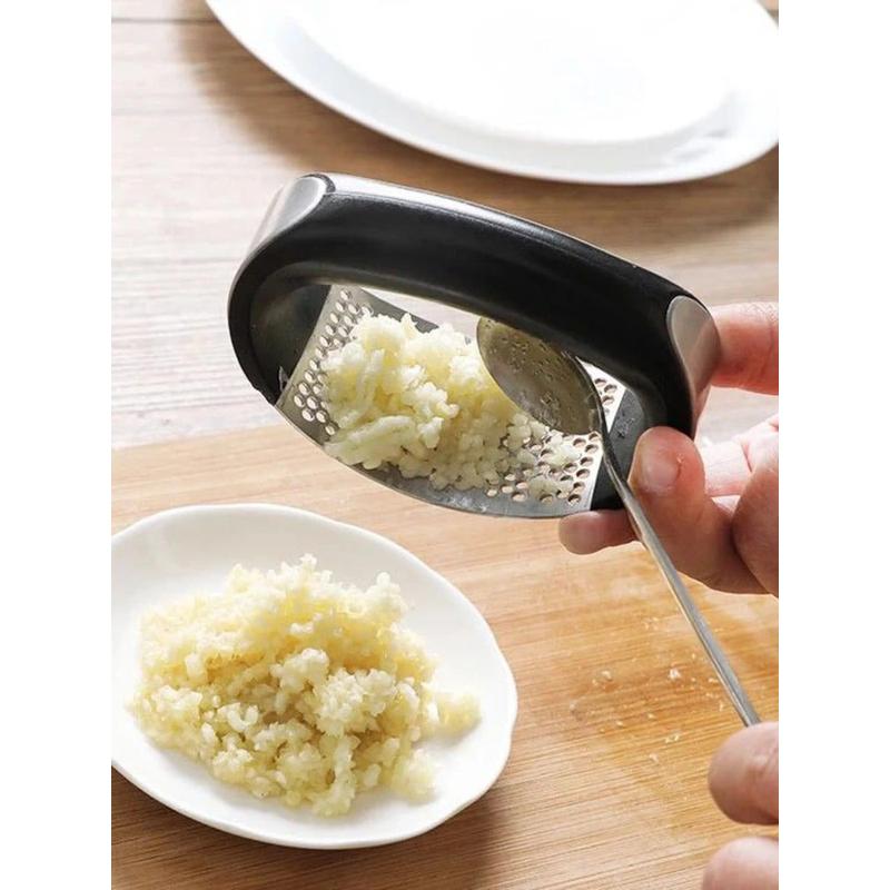 Curved garlic press kitchen tool showing construction