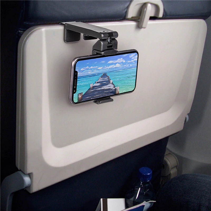 Universal phone holder clip attached to airplane tray table